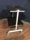 2 Shelf Rolling Equipment Cart:  Steel constructed with solid casters, two of them locking.
Meant for heavy items.